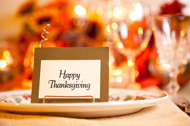 istock Happy Thanksgiving place setting with autumn flower centerpiece. 589941708