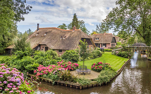 Giethoorn, Netherlands - August 9, 2016: Farms with thatched roofs in Giethoorn, Holland