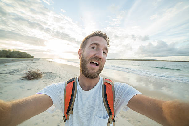 istock Self portrait of young man by the beach 589943162