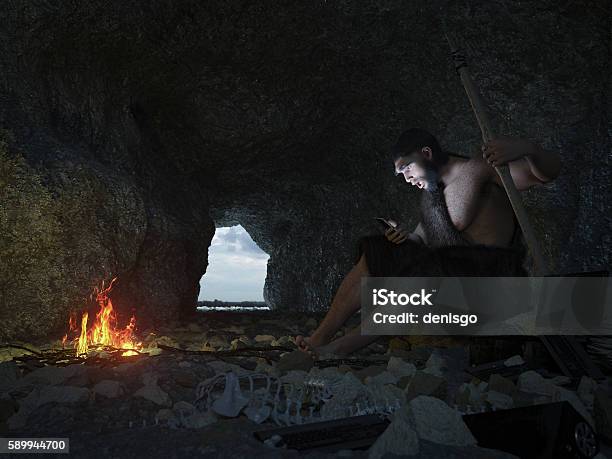Primitive Man Siting In The Cave With Smartphone Concept Illustration Stock Photo - Download Image Now