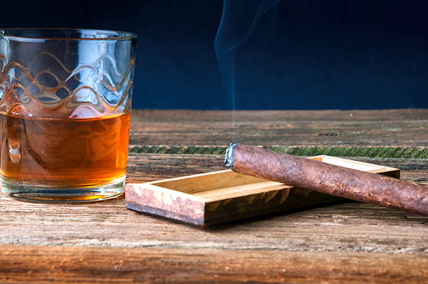 istock Whisky and cigar on wooden table 589944778