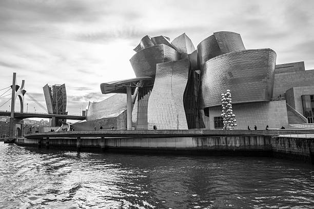 view of modern and contemporary art Guggenheim Museum Bilbao, Spain - January 30, 2016: black and white view of modern and contemporary art Guggenheim Museum, designed by American architect Frank Gehry and inaugurated in October 1997. frank gehry building stock pictures, royalty-free photos & images