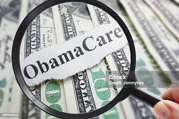 Obamacare And Magnifying Glass Stock Photo - Download Image Now - Patient Protection and Affordable Care Act, Budget, Care