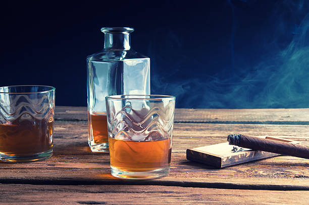 istock Whisky and cigar on wooden table 589945768