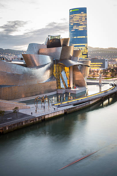 Evening view of modern and contemporary art Guggenheim Museum Bilbao, Spain - January 29, 2016: evening view of modern and contemporary art Guggenheim Museum, designed by American architect Frank Gehry and inaugurated in October 1997. estuary photos stock pictures, royalty-free photos & images