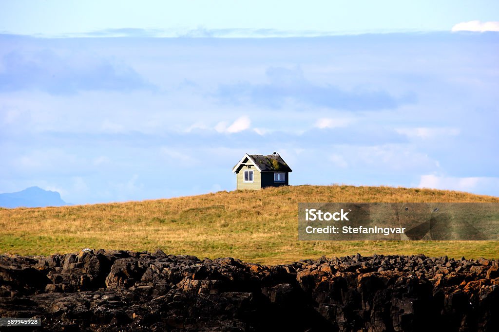 Small house on a small Island A small house on a small island in Iceland House Stock Photo