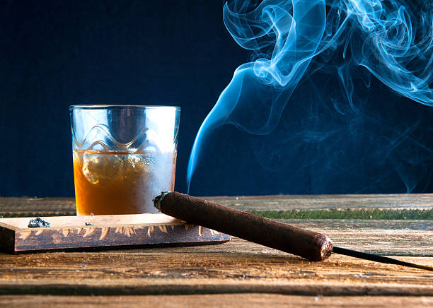 istock Whisky with ice and cigar on wooden table 589946636