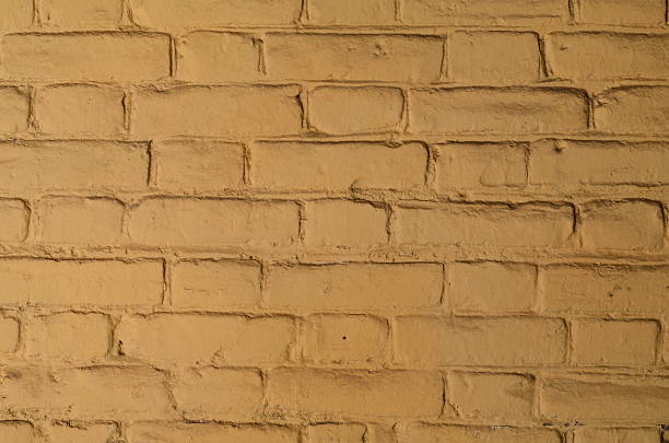istock Texture of old yellow brick wall surface with cement 589946772