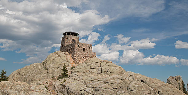 istock Harney Peak Fire Lookout Tower under cumulus cirrus cloudscape 589947246