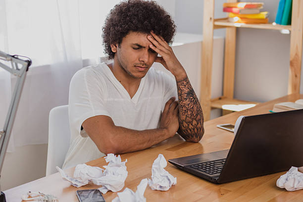 istock Tired man sitting on a workplace at home 589947548