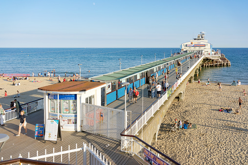 Bournemouth/UK. 14th August 2016. Unidentified day trippers enjoy the warm sunshine and crystal clear waters of Bournemouth beach and the facilities of the Victorian Pier on the UK's south coast. 