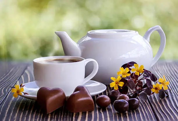 Dark chocolate,candy and cup of coffee  on a wooden tableDark chocolate,candy and cup of coffee  on a wooden table