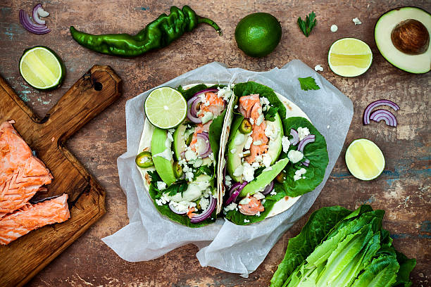 Preparing healthy lunch snacks. Fish tacos with grilled salmon