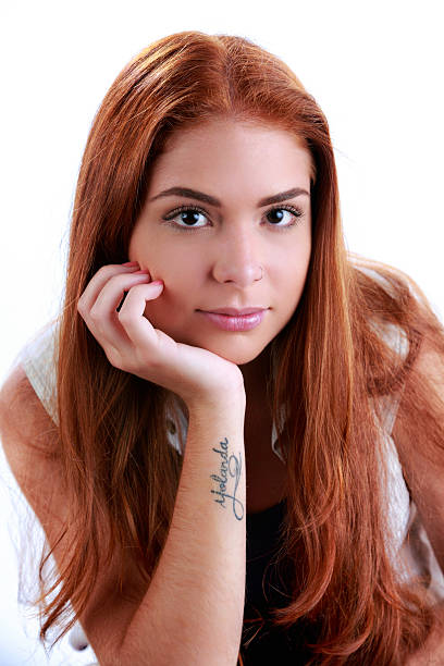 istock Self confident Hispanic redhead young woman looking at camera 589952116