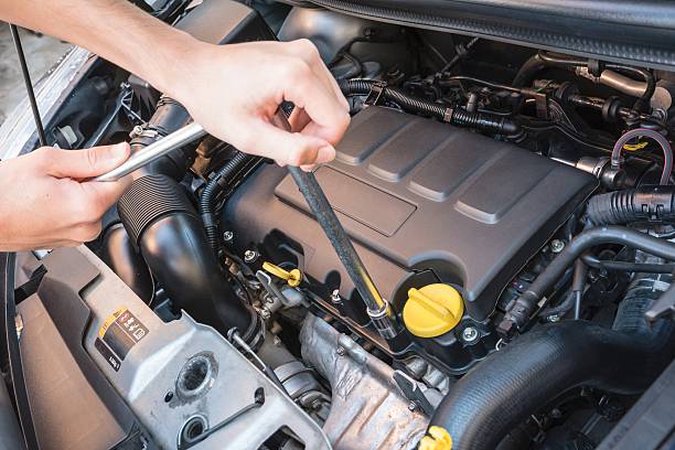 istock Hands repairing a car engine with a wrench 589952148
