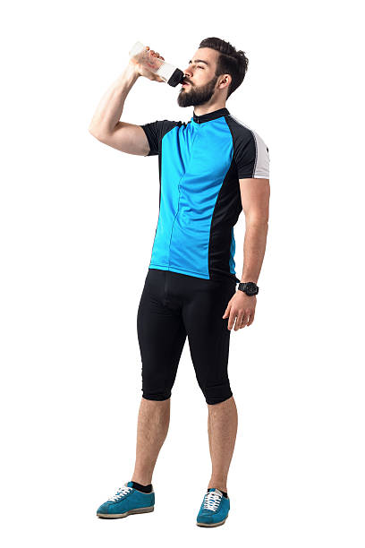 istock Exhausted athlete in bicycling sportswear drinking water from plastic bottle 589953500