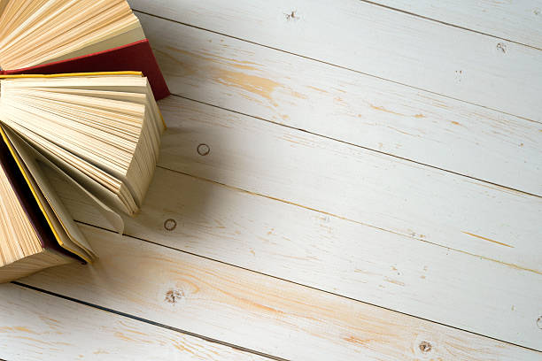 istock Top view of bright colorful hardback books in a circle. 589955344