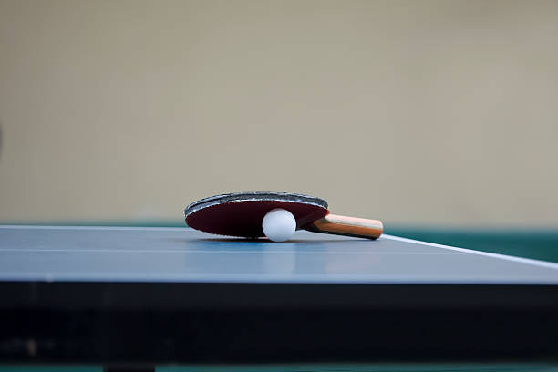 istock Table Tennis racket and ball on a Table Tennis Table 589956364