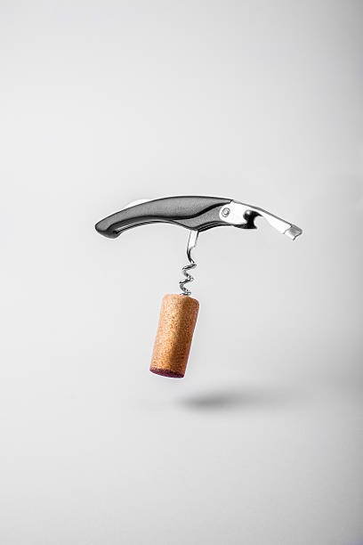 Wine cork and bottle opener Wine cork and bottle opener floating on white background uncork wine stock pictures, royalty-free photos & images