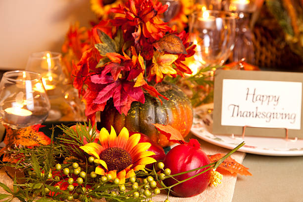 istock Happy Thanksgiving place setting with autumn flower centerpiece. 589957852