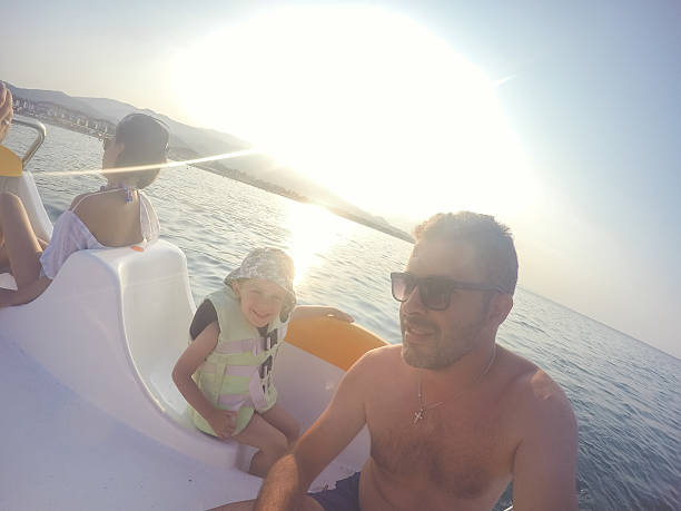 istock Family on a paddle boat in the sea 589958080