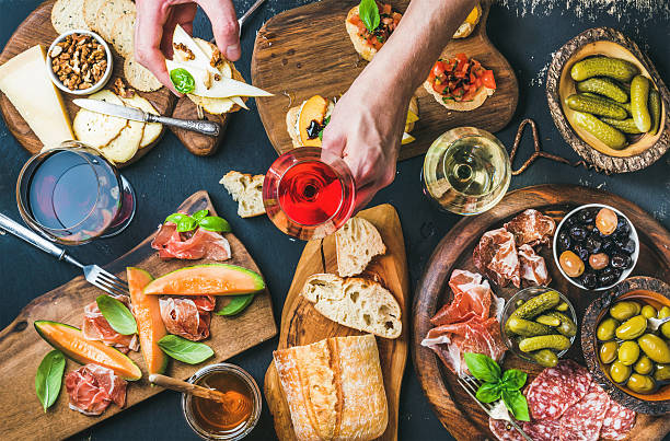 istock Italian wine snacks set, man's hand holding glass of 589959350