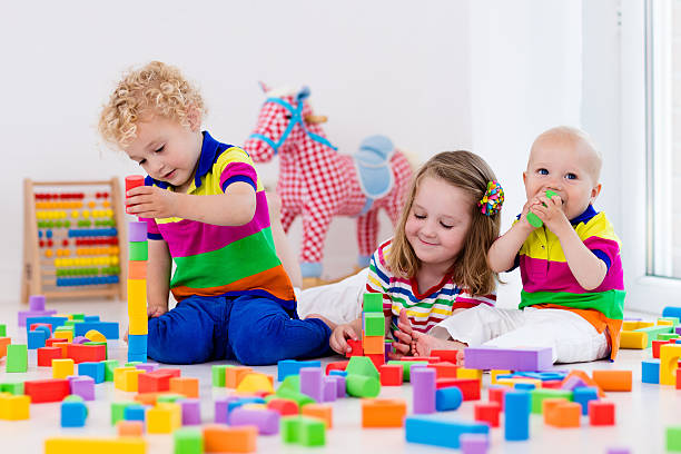 istock Kids playing with colorful toy blocks 589961022
