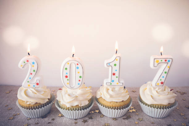 istock 2017 Happy New Year Cupcakes with fairy light toning background 589962194