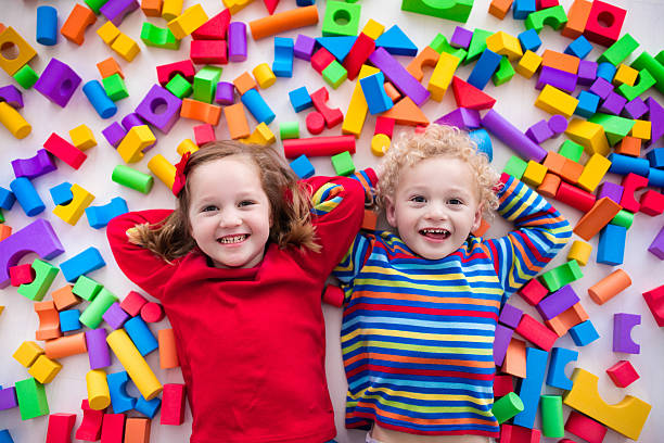 istock Sweet children playing with colorful blocks. 589962930