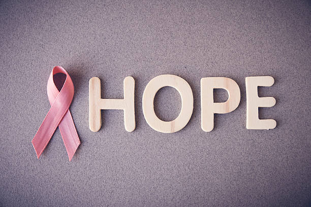 Pink Ribbon with HOPE wooden letters,Breast cancerawareness Pink Ribbon with HOPE wooden letters, toning, Breast cancer awareness and Abdominal cancer awareness stomach knot stock pictures, royalty-free photos & images