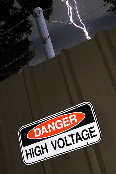 istock Lightning strikes near High Voltage sign 589964878
