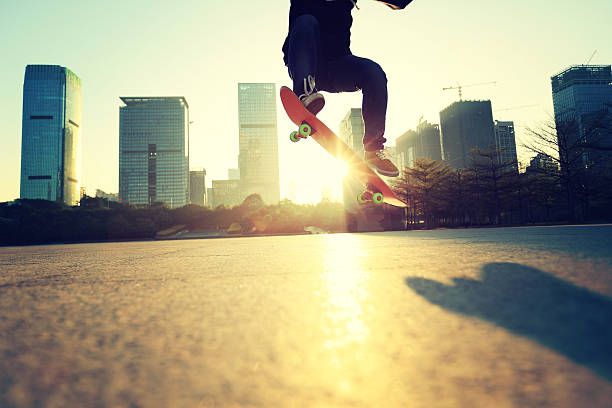 istock skateboarding legs doing an ollie trick at sunrise city 589965716