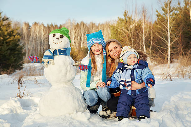 istock family with snowman 589967968