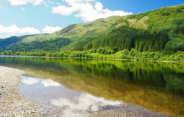 istock Beautiful lake against big mountain and blue sky background 589967972