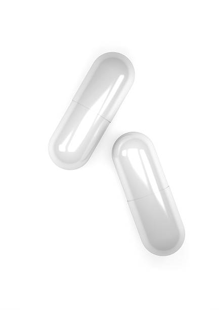 istock pills capsules isolated on white background 589968326