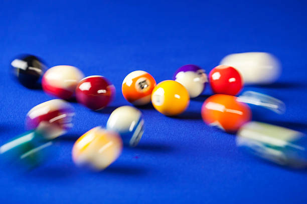 blurry and moving of billiard balls blurry and moving of billiard balls in a blue pool table pool ball stock pictures, royalty-free photos & images