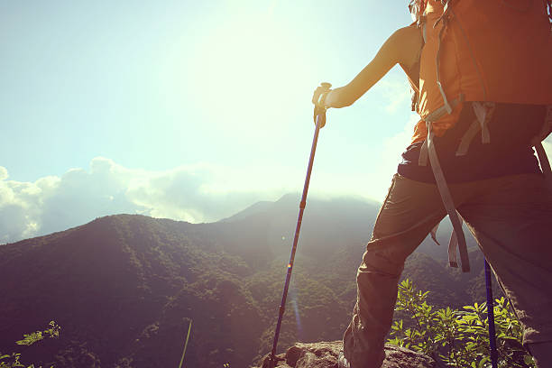 istock young woman backpacker enjoy the view on mountain peak 589970378