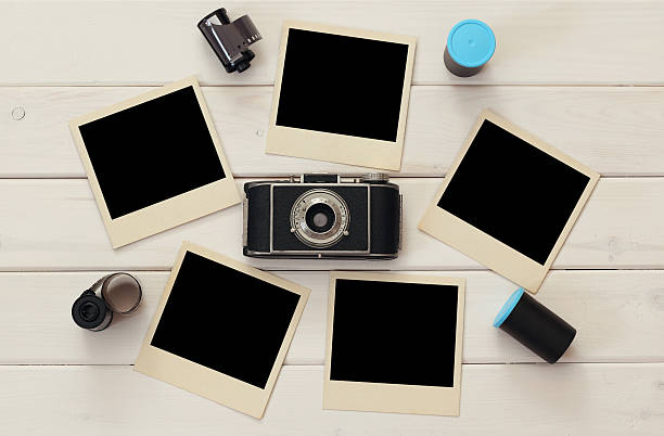 istock empty instant photographs next to old camera and film rolls 589970434