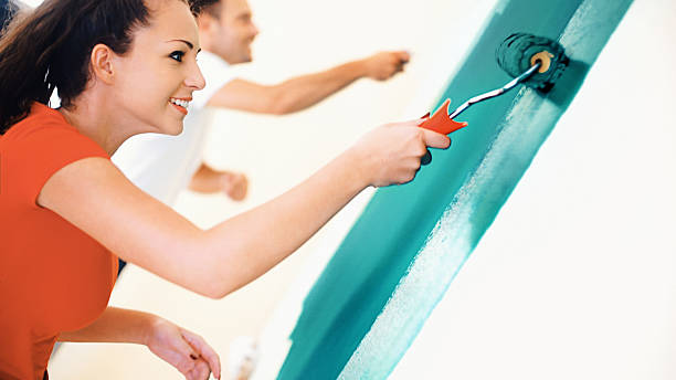 istock Young couple decorating apartment. 589970492