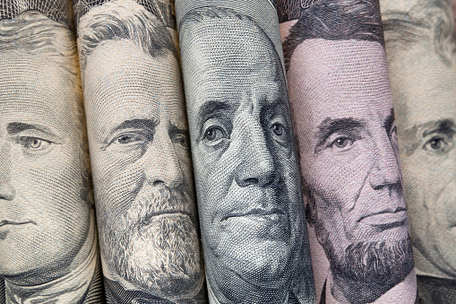 Portraits of U.S. presidents on dollar bills.