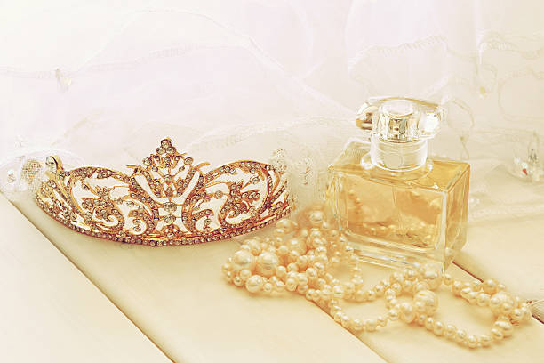 istock White pearls necklace, diamond tiara and perfume bottle 589971096