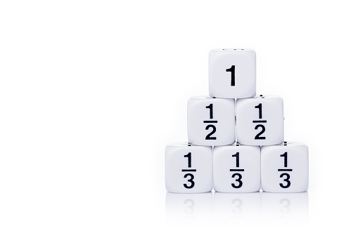 White fraction dices, whole, half, third, stacked up on white background with light reflection and copy space for text