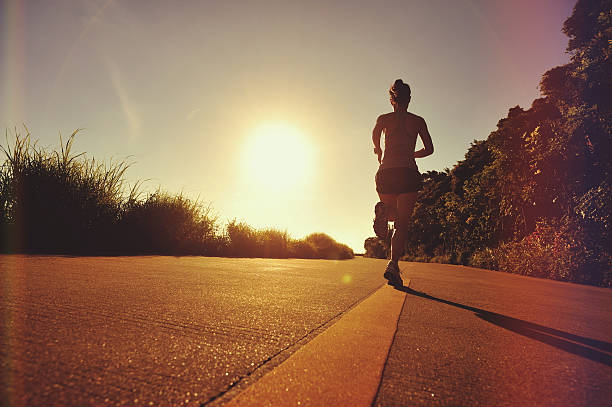 istock young woman runner running on sunrise seaside 589974356