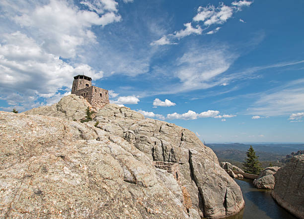 istock Harney Peak Lookout Tower and pump house for small dam 589974712