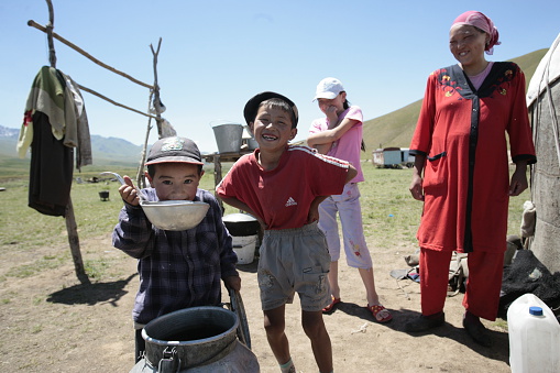 Valley Susamyr, Chuy Region, Kyrgyzstan July 20, 2007. Children of cattle breeders on a pasture Susamyr drink water.