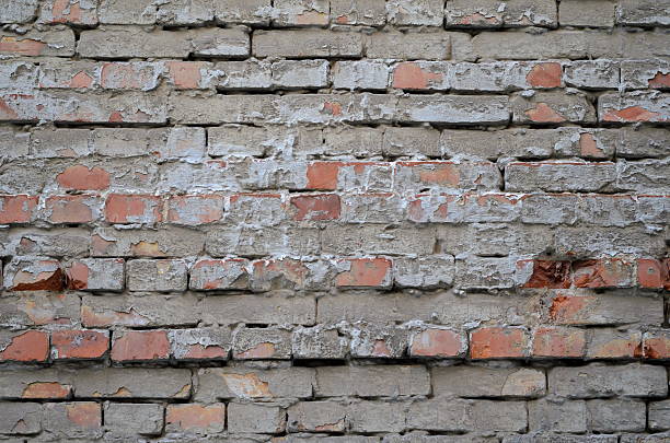 istock Texture of old red brick wall surface with cement 589975920