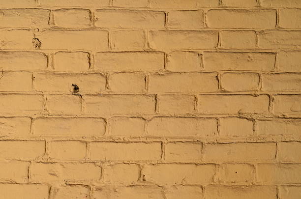 istock Texture of old yellow brick wall surface with cement 589976046