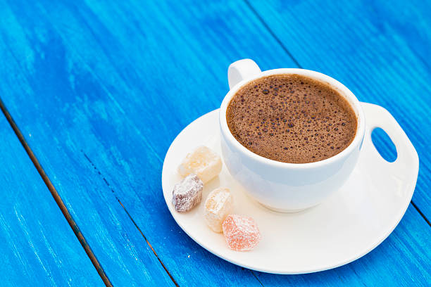 istock Turkish coffee with delight on wooden background 589979688