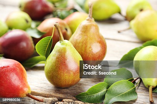 istock Ripe pears on grey wooden table 589980036