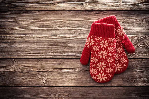 red mittens on wooden background